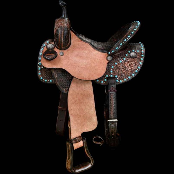 Our Flying Colors Saddle is built for speed.   With a deep brown strain on this combo of  floral and Waffle Weave hand tooling accented with a bazillion of Turquoise colored pieces.